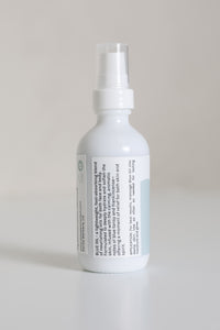 Dresden Holden Acupuncturist in santa barbara california 2 ounce bottle of organic facial oil using frankincense and blue tansy essential oil in a white glass bottle with a blue label and blue writing in an elegant style. 
