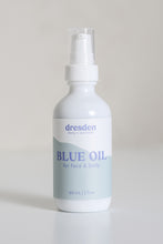 Load image into Gallery viewer, Dresden Holden Acupuncturist in santa barbara california 2 ounce bottle of organic facial oil using frankincense and blue tansy essential oil in a white glass bottle with a blue label and blue writing in an elegant style. 
