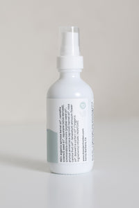 Dresden Holden Acupuncturist in santa barbara california 2 ounce bottle of organic facial oil using frankincense and blue tansy essential oil in a white glass bottle with a blue label and blue writing in an elegant style showing the INCI list