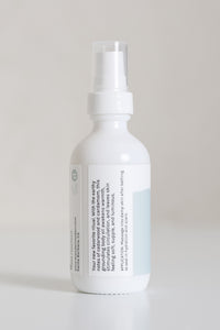 Dresden Holden Body and Wellness acupuncturist based in Santa Barbara california made this organic body oil with the scents of cardamom and cedar, fast absorbing and dry oil feel, a 2 ounce white glass bottle with a blue and white label in blue writing. 