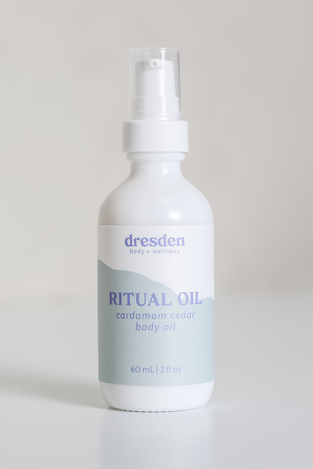 Dresden Holden Body and Wellness acupuncturist based in Santa Barbara california made this organic body oil with the scents of cardamom, fast absorbing and dry oil feel, a 2 ounce white glass bottle with a blue and white label in blue writing. 