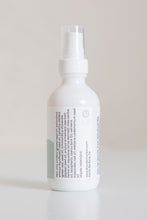Load image into Gallery viewer, Dresden Holden Body and Wellness acupuncturist based in Santa Barbara california made this organic body oil with the scents of cardamom, fast absorbing and dry oil feel, a 2 ounce white glass bottle with a blue and white label in blue writing. 
