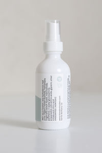 Dresden Holden Acupuncturist in Santa Barbara Ca made Silk water a hydrating toner with organic hydrosols, niacinamide, glycerin, silk amino acids, and is pH balanced to hydrate and heal the skin barrier, in a 2 ounce white glass bottle with a label written in blue font