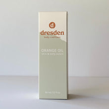 Load image into Gallery viewer, Dresden Body + Wellness orange oil, skin and body and belly oil, box with green mountain background, santa barbara, california
