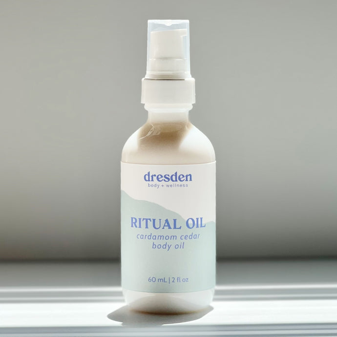 Dresden Body + Wellness Santa Barbara based acupuncturist and skincare studio. 2 ounce bottle of body oil with vetiver, cardamom and cedarwood, in a glass bottle